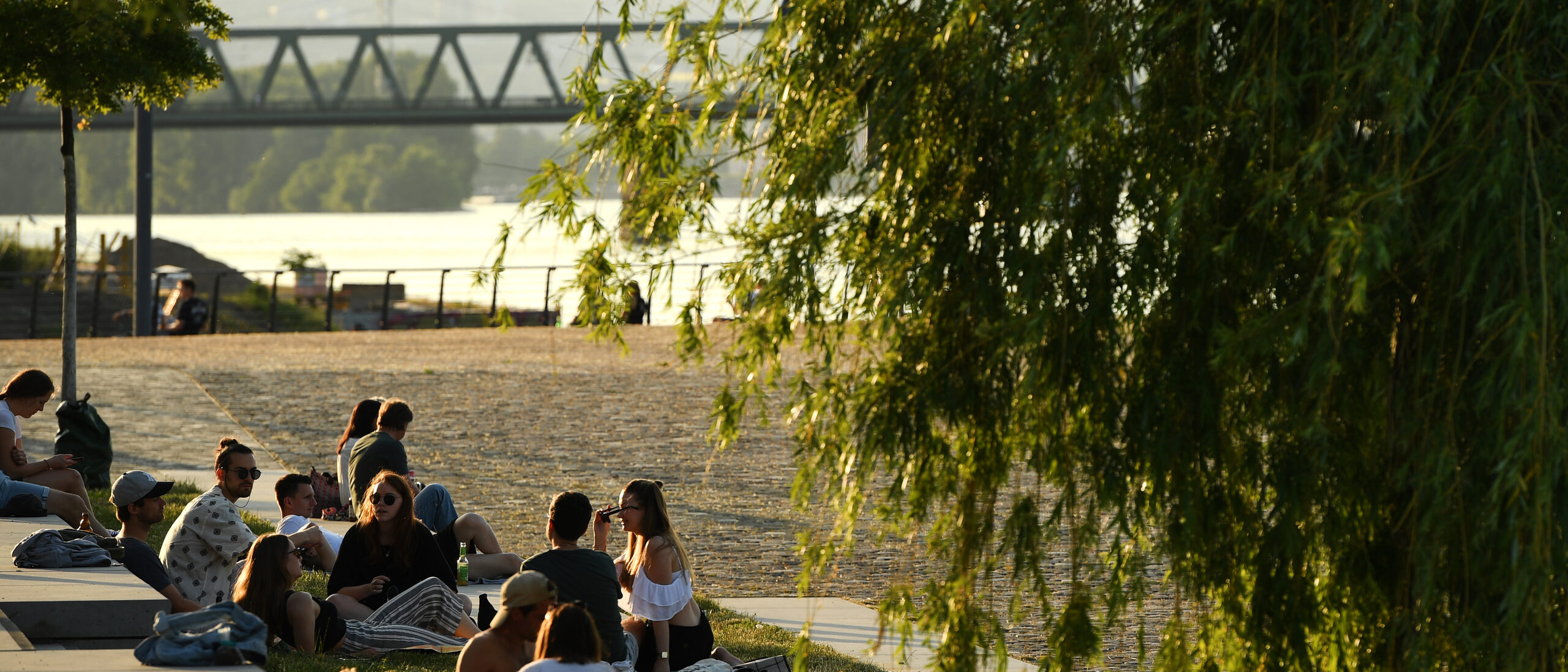 People sitting on the banks of the Rhine at the customs port