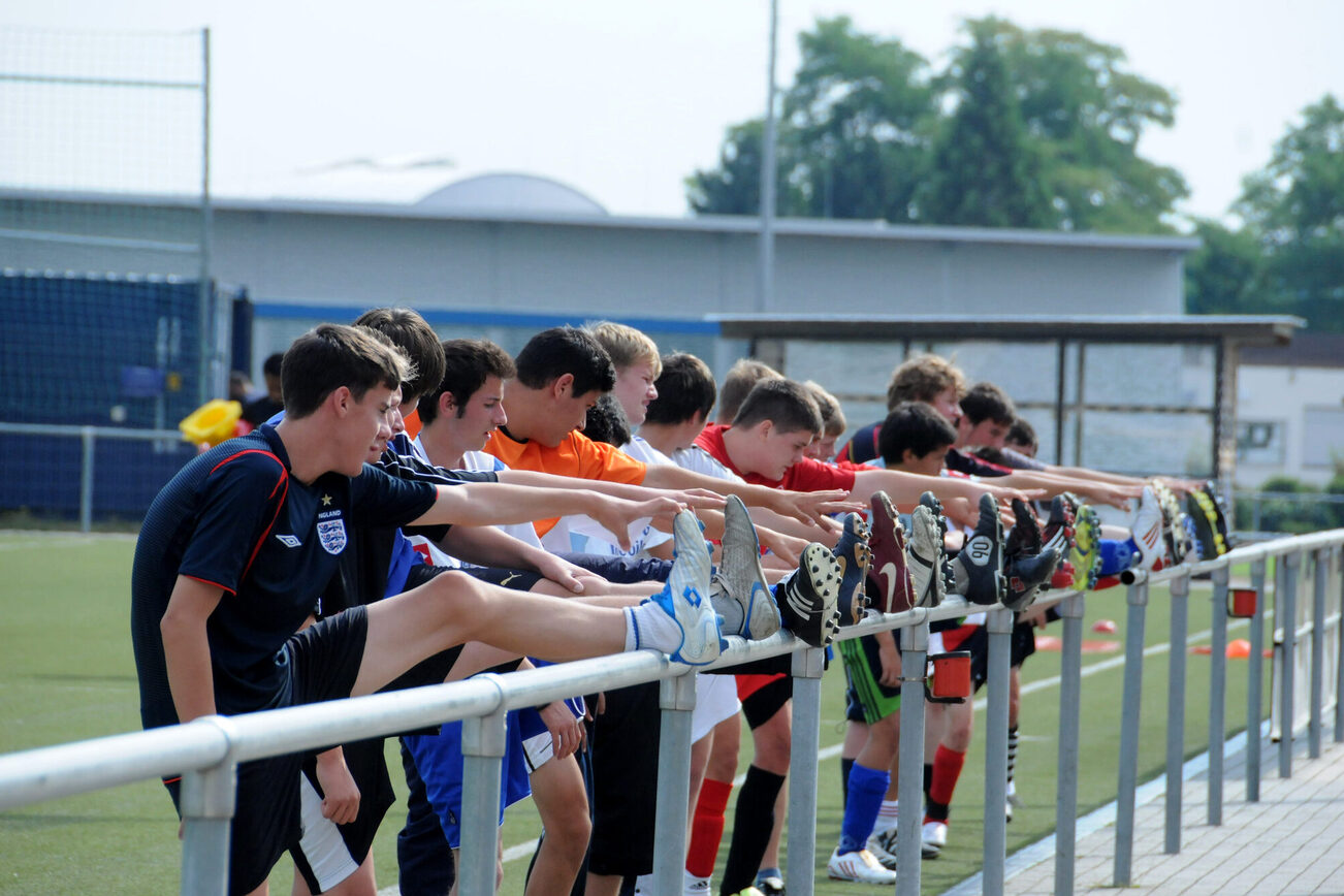 Young soccer players stretching.